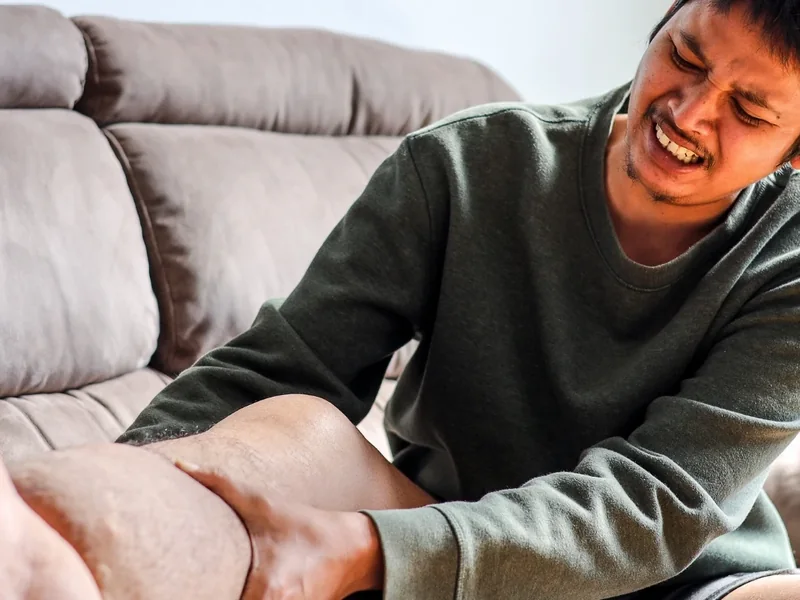 Therapist measuring limb swelling during a lymphedema evaluation